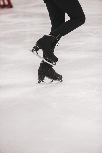 Wearing a black jacket and black pants playing ice hockey
